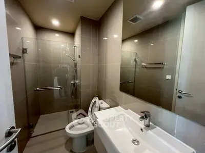 Modern bathroom with sleek fixtures and glass shower enclosure