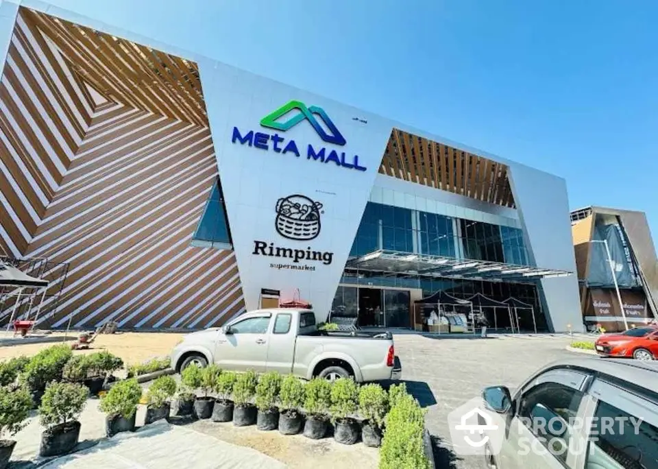 Modern Meta Mall exterior with unique architectural design and ample parking space.