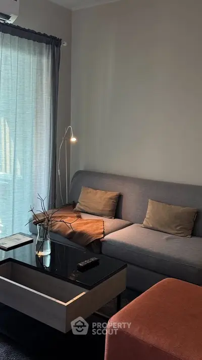 Cozy living room with modern sofa and stylish decor, perfect for relaxation and entertainment.