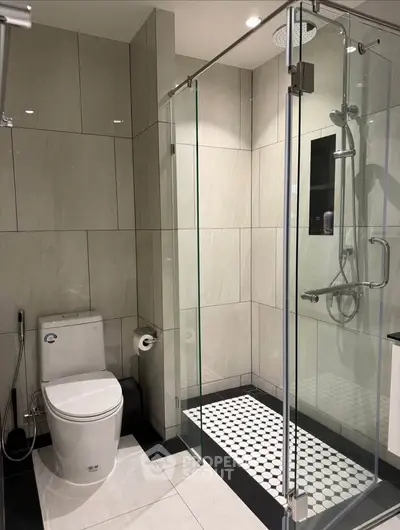 Modern bathroom with glass shower and sleek tile design