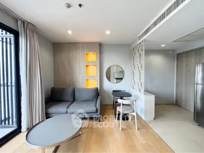 Modern living room with stylish decor and open layout, featuring a cozy sofa and dining area.