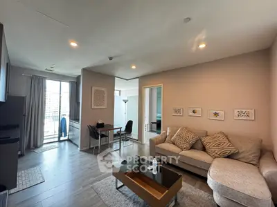 Modern living room with stylish decor and balcony view in urban apartment