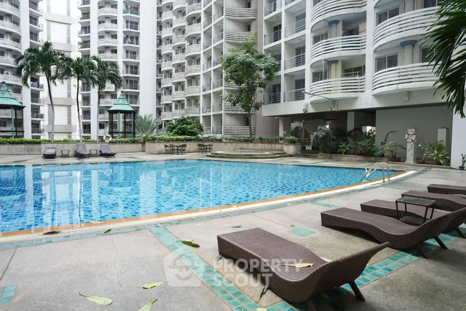 Luxurious apartment complex with stunning poolside view and modern amenities.