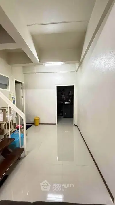 Spacious hallway with modern staircase and sleek flooring