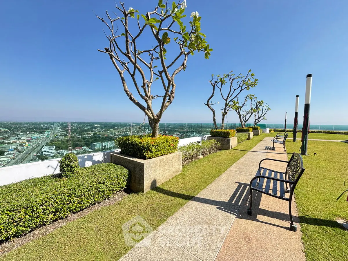 Stunning rooftop garden with panoramic city views and seating area.