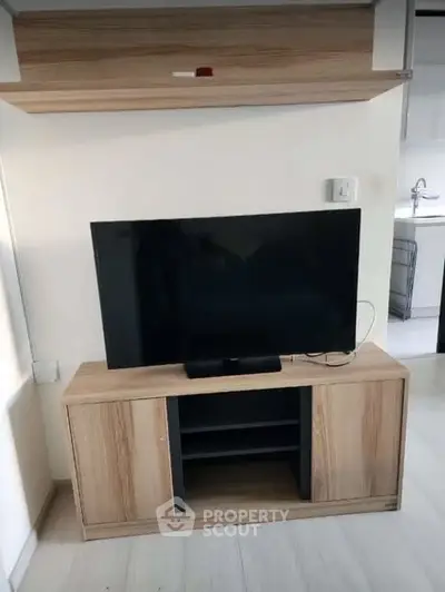 Modern living room with sleek TV stand and wall-mounted shelf