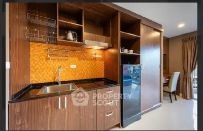 Modern kitchen with sleek wooden cabinets and orange backsplash