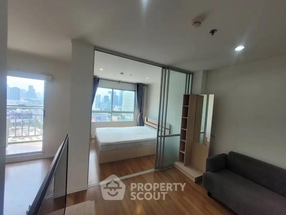 Modern apartment with city view, featuring a cozy bedroom and spacious living area with wooden flooring.