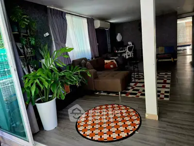 Spacious living room with modern decor and large windows for natural light.