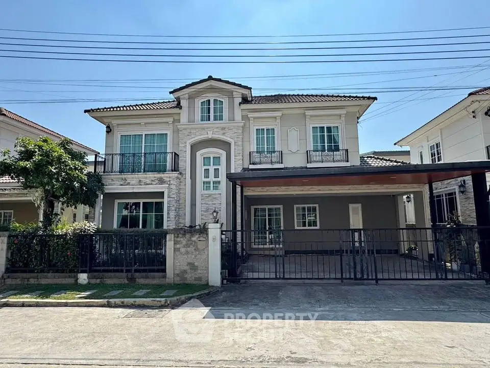 Elegant two-story house with spacious driveway and charming facade in a suburban neighborhood.
