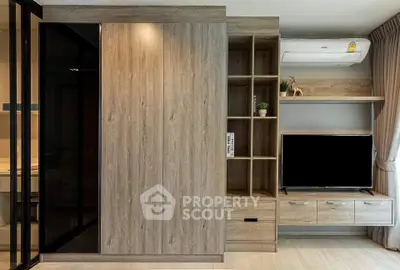 Modern living room with wooden cabinetry and sleek TV setup