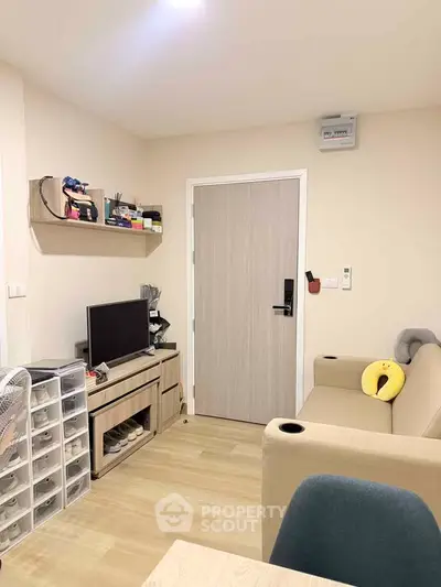 Cozy living room with modern decor and entertainment setup in a stylish apartment.