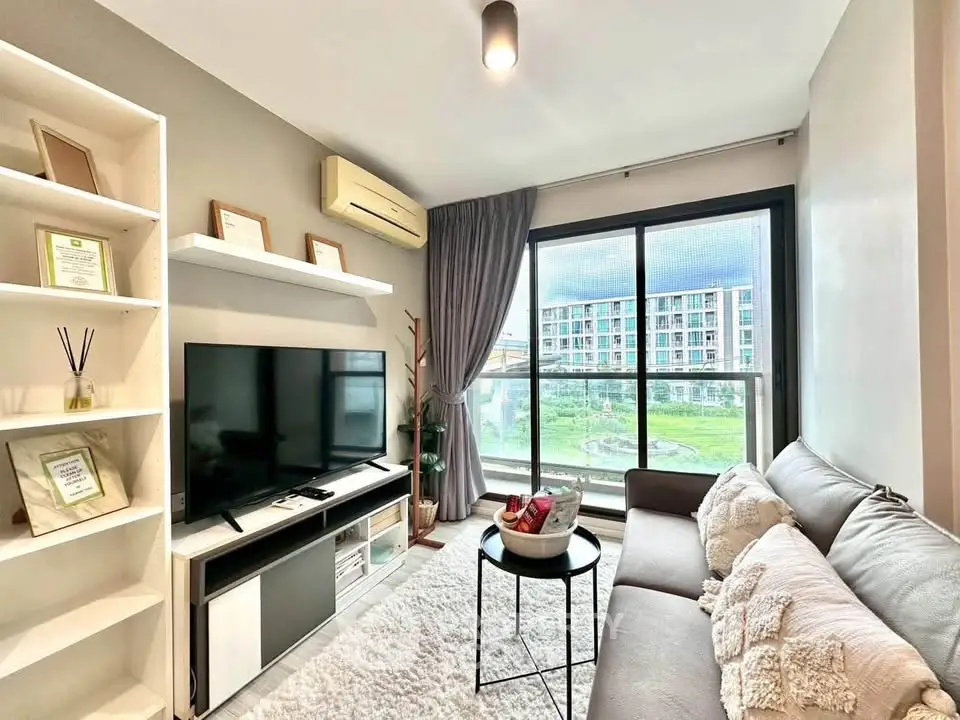 Modern living room with large window and cozy decor in urban apartment