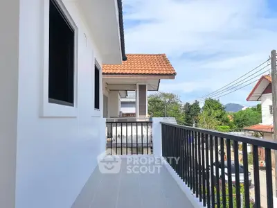 Charming balcony with scenic neighborhood view in a modern residential area.