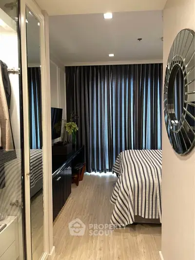 Modern bedroom with stylish decor and floor-to-ceiling curtains