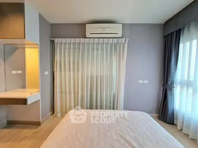 Modern bedroom with air conditioning and large window for natural light