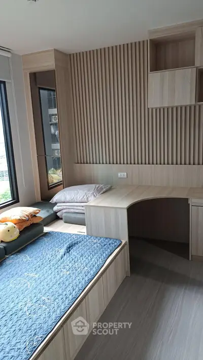 Modern bedroom with built-in wooden furniture and large window view