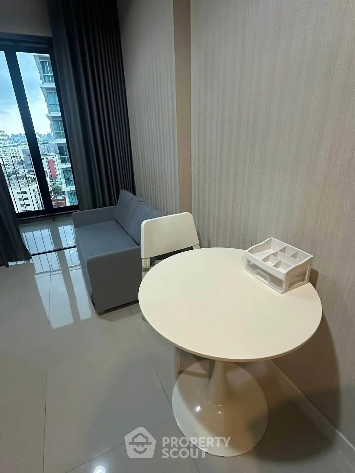 Modern living room with sleek furniture and city view from window