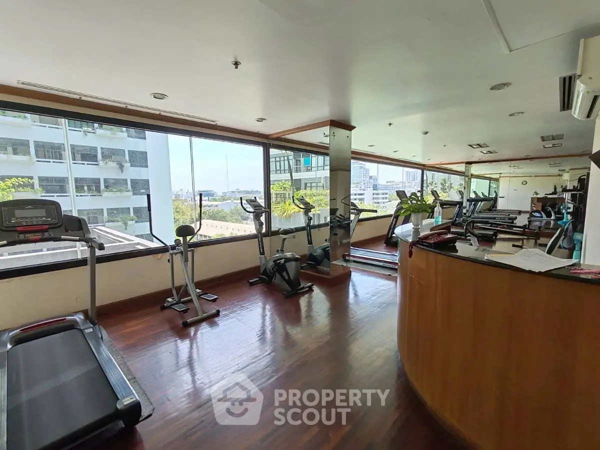 Spacious gym with modern equipment and panoramic city views