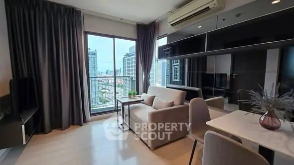 Modern living room with city view, sleek furniture, and large windows in a high-rise apartment.