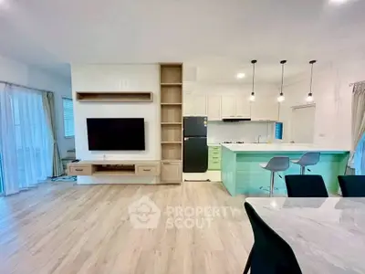 Modern open-plan living room with sleek kitchen and stylish decor