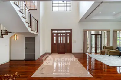 Spacious and elegant living room with high ceilings and wooden flooring