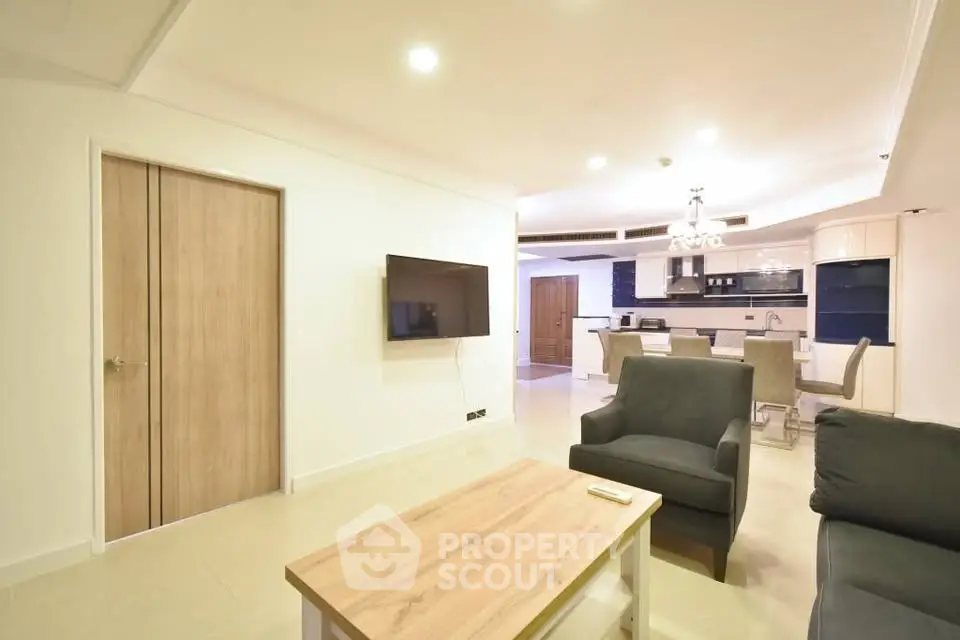 Spacious modern living room with open kitchen layout and stylish furniture