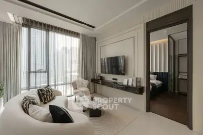 Modern living room with elegant decor and large windows offering city views.
