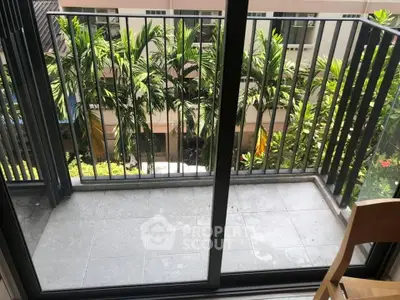 Charming balcony with lush garden view, perfect for relaxation and enjoying nature.