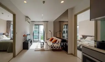 Modern apartment interior with open living room and bedroom view, stylish decor.