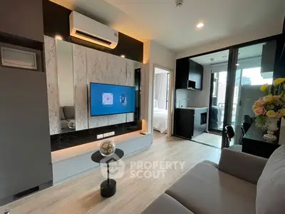 Modern living room with stylish decor and open kitchen layout in urban apartment.