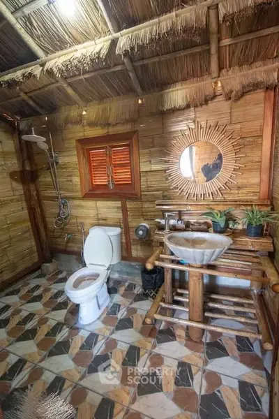 Rustic bamboo-themed bathroom with unique wooden fixtures and natural decor.