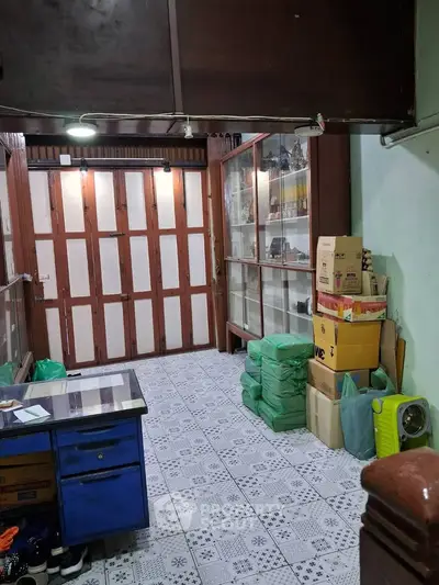 Spacious storage room with tiled floor and ample shelving, ideal for organizing and storing items efficiently.