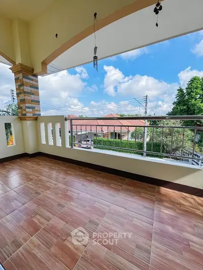Spacious balcony with scenic view and tiled flooring in a modern home