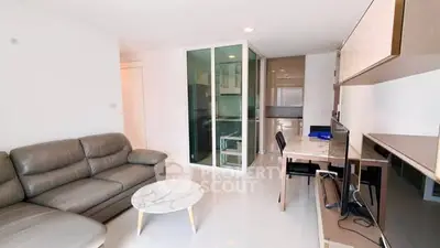 Modern living room with sleek furniture and open kitchen layout