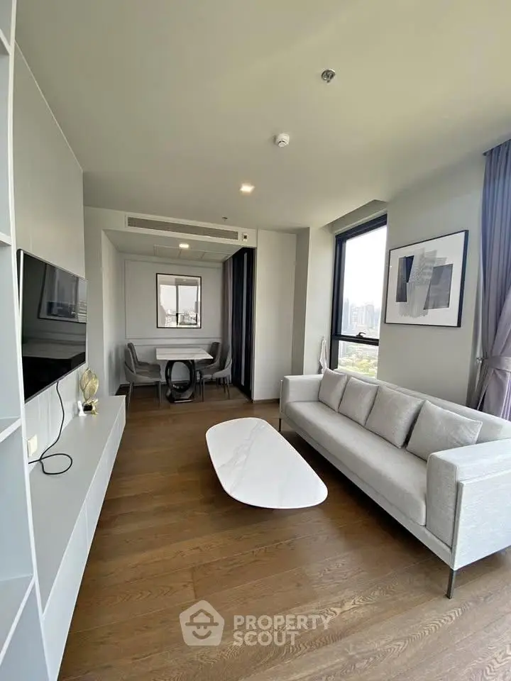 Modern living room with sleek furniture and city view, perfect for urban living.