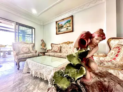 Luxurious living room with elegant furniture and artistic decor, featuring a unique sculpture centerpiece.