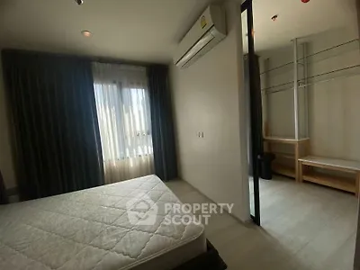 Spacious bedroom with natural light and walk-in closet