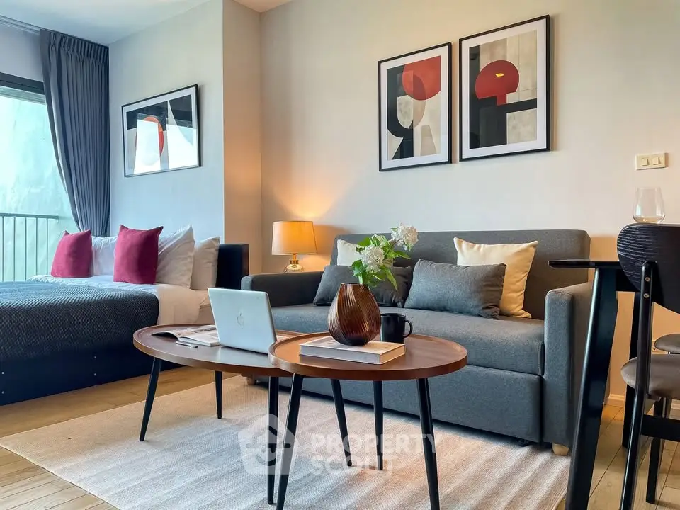 Modern studio apartment with stylish decor, featuring a cozy living area and a comfortable bed.