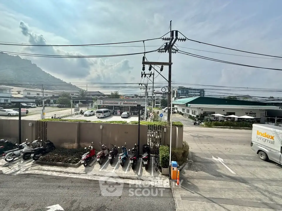 Scenic view from a property showcasing urban landscape and mountain backdrop, ideal for city living enthusiasts.