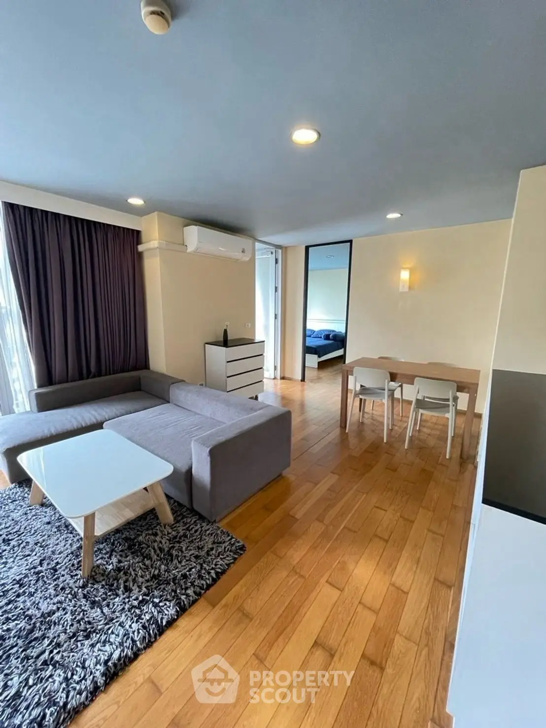 Spacious modern living room with wooden floors and stylish furniture