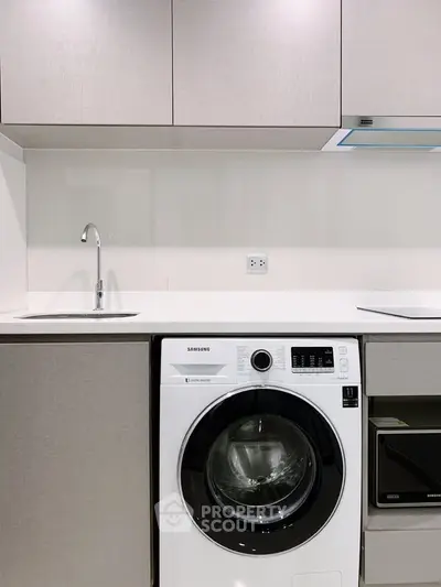 Modern kitchen with integrated washing machine and sleek cabinetry