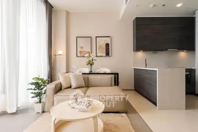 Modern open-layout living room with stylish kitchen and cozy seating area, perfect for urban living.