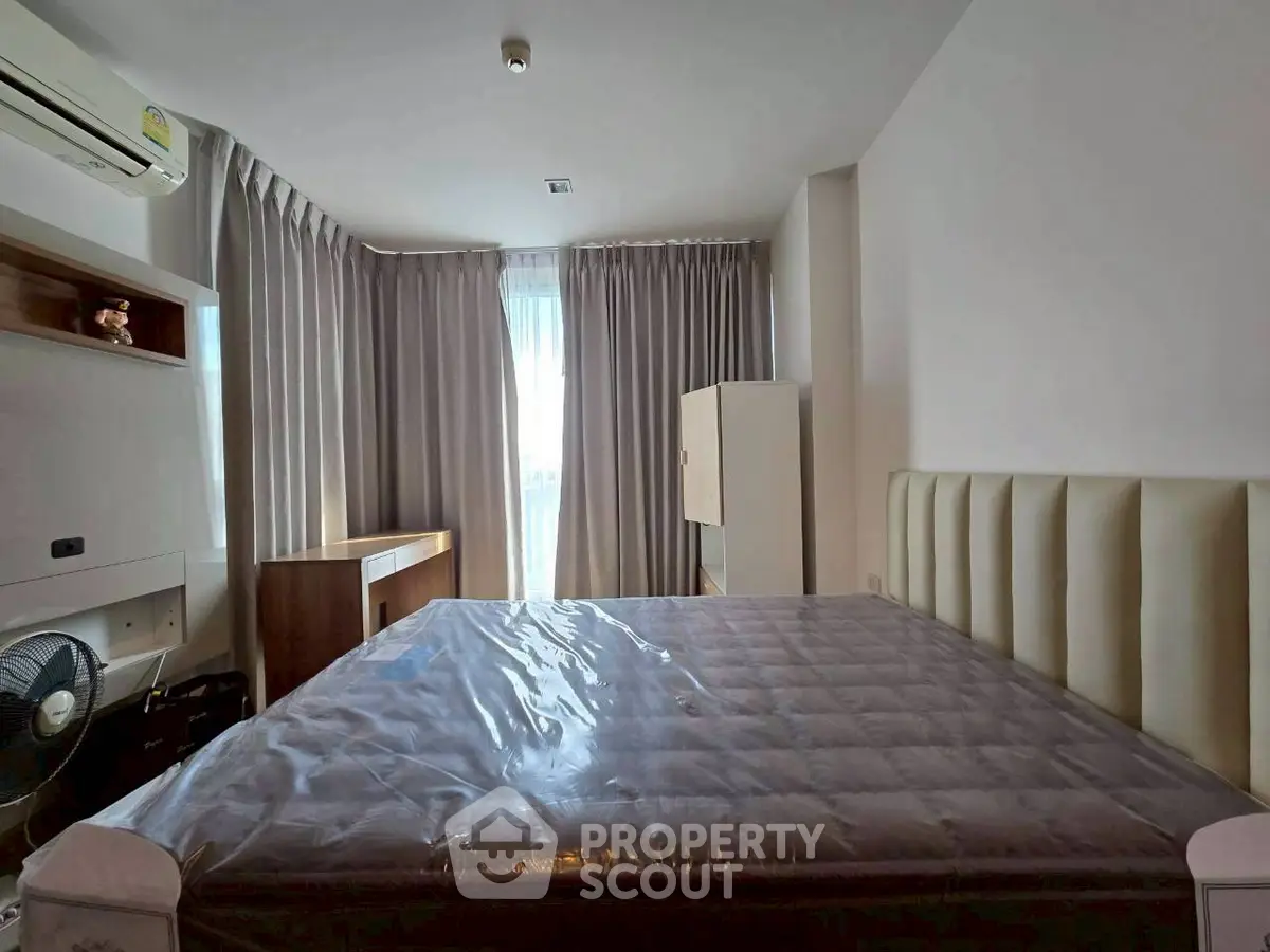 Spacious bedroom with modern furnishings and natural light