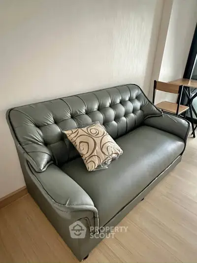 Stylish leather sofa in modern living room with wooden flooring and elegant decor.