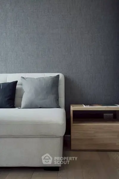 Modern living room with stylish sofa and wooden side table, perfect for contemporary urban living.