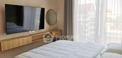 Modern bedroom with wall-mounted TV and large window view