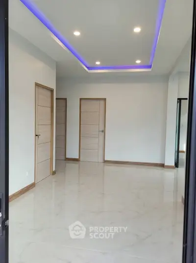 Modern interior with sleek lighting and marble flooring, showcasing contemporary design.