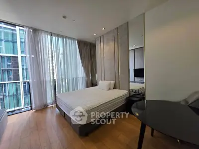 Modern bedroom with floor-to-ceiling windows and city view in luxury apartment