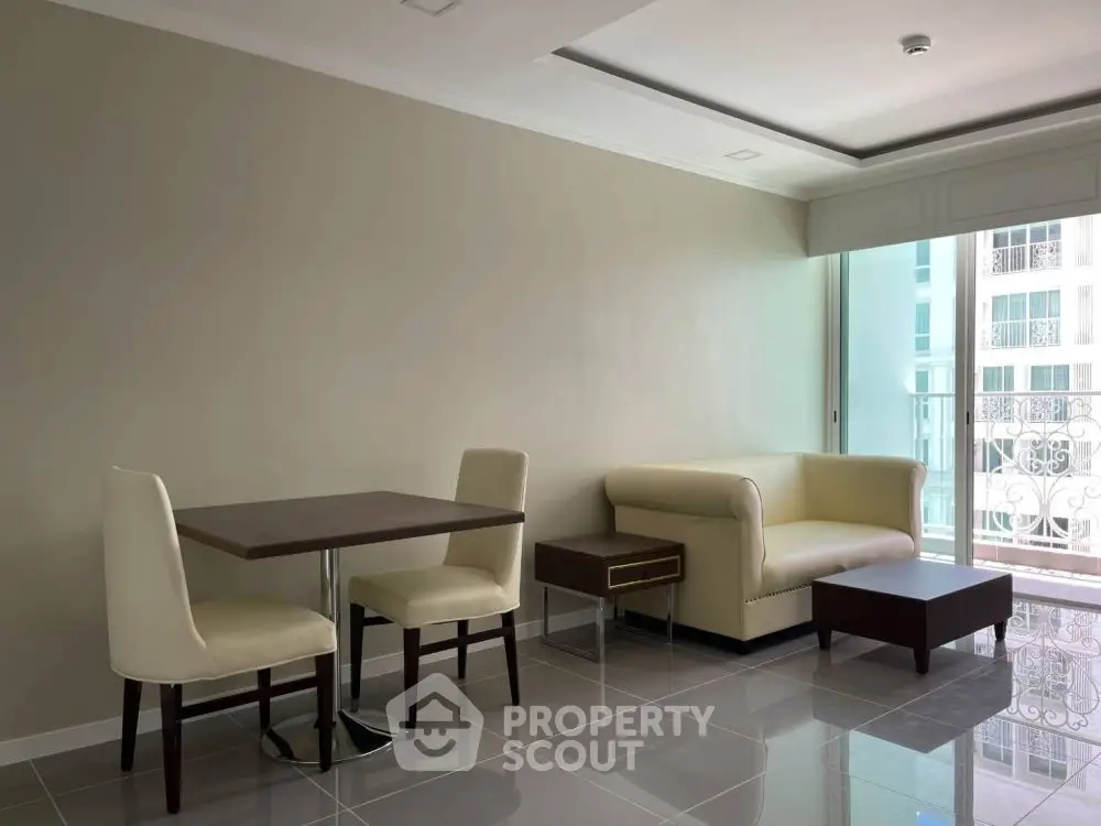 Modern living room with sleek furniture and balcony view in a stylish apartment.